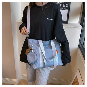 Light blue nylon tote bag with a matching mini round coin purse and orange label