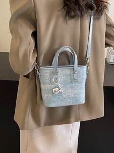 Light blue mini bucket bag with tweed texture, top handles and silver ball pendant