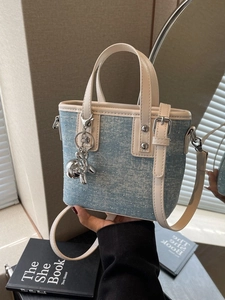 Blue denim mini bucket bag with rhinestones, leather trim and a silver balloon dog charm