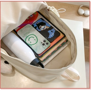 Detailed interior view of a high-capacity beige backpack showing multiple storage pockets