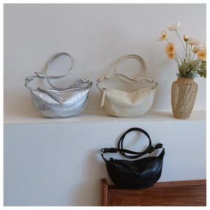 Detail of half-moon leather shoulder bags with adjustable knotted straps in soft texture