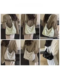 Three stylish hobo bags in mint green, silver, and black with chain straps and metal butterflies
