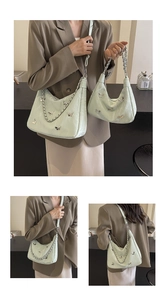 Detailed comparison of large and small mint green textured bags with butterfly metal decor