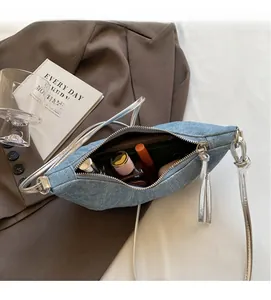 Interior view showing the storage capacity of the light blue denim croissant bag