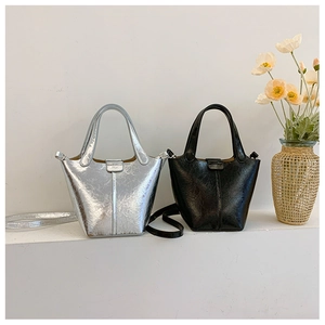 Detail view of silver and black leather bucket bags with pleated texture and dual handles