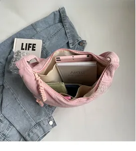 Interior view of large capacity corduroy dumpling bag with multi-pocket lining and tablet