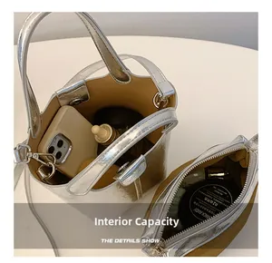 Internal capacity of silver bucket bag showing phone and cosmetic accessories