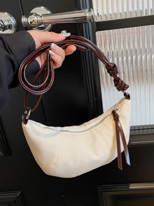 Minimalist cream canvas crescent hobo bag with contrast leather straps and silver hardware