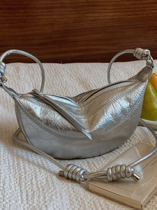 Metallic silver crescent moon shoulder bag with wrinkled leather and knot detail