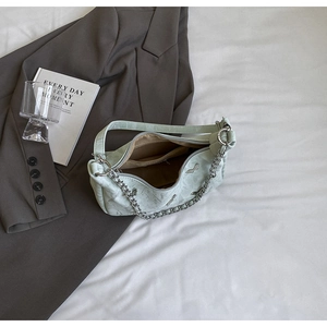 Detail of mint green marble texture tote bag with silver butterfly and chunky chain