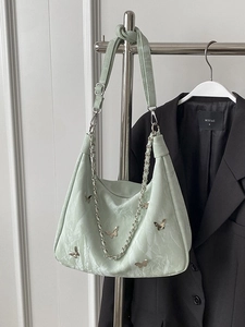 Light green hobo shoulder bag with silver butterfly charms and pleated texture finish