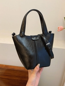Glossy black oil-wax leather bucket bag with top handle and silver strap hardware