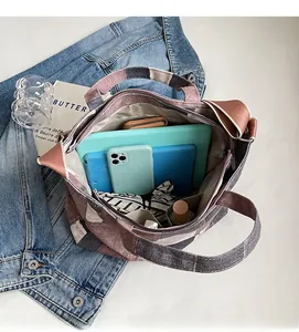 Interior view showing the large capacity and multiple storage compartments of the denim tote bag