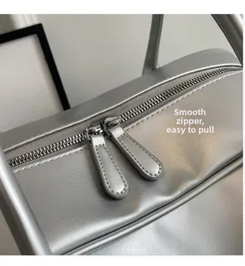 Detail view of smooth silver metallic zipper and premium synthetic leather texture