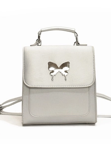 Sac à dos argenté perlé avec boucle papillon en métal et poignée supérieure