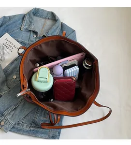 Top view showing the spacious interior of this large brown tote bag with various items