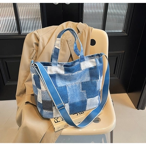 Close-up of retro denim patchwork tote bag with adjustable strap and detailed stitching