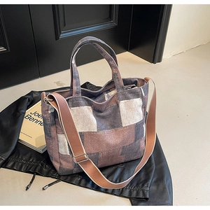 Detail view of multi-color patchwork denim tote bag with adjustable brown strap