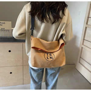 Detail showing high-density khaki canvas material and adjustable black shoulder strap