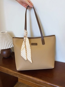 Large warm brown tote bag in pebbled leather with contrast handles and silk scarf detail