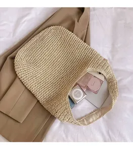 Top view of straw tote bag interior showing large capacity for cosmetics and gadgets