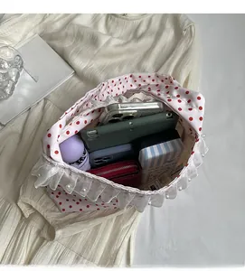 Spacious interior of white polka dot tote bag with lace and pearl details