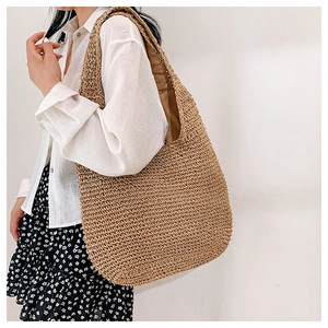 Close-up of hand-woven straw tote bag texture and large capacity holiday style design