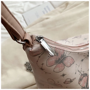 Detail of silver zipper and butterfly constellation print on pink shoulder tote bag