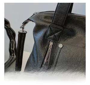 Close-up detail of smooth silver metal zipper and lychee pattern leather texture