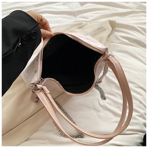 Top view of open light pink tote bag showing black fabric lining and silver chain detail