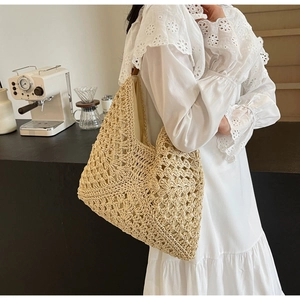 Detailed texture of beige crochet tote bag featuring intricate geometric hollow patterns