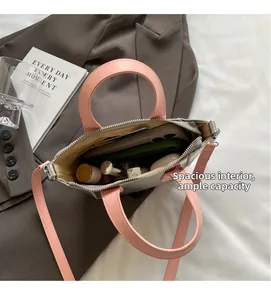 Detail of color-block bucket bag interior showing spacious storage for daily essentials