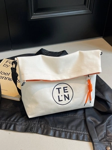 White canvas tote bag with orange lining and logo, perfect for modern casual commute style