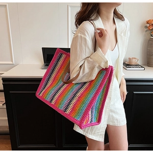 Detail of colorful rainbow crochet tote bag with durable brown leather handles