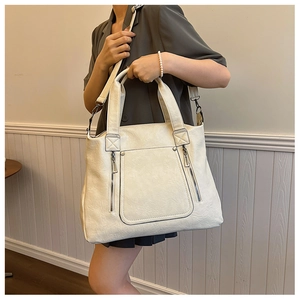 Detail of cream soft leather tote bag showing large capacity and adjustable shoulder strap