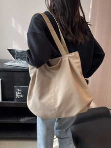 Minimalist khaki canvas tote bag with leather straps and large capacity for daily commute