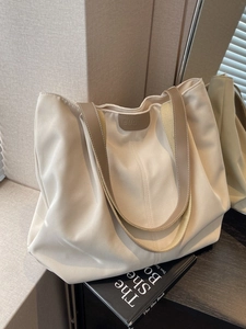 Minimalist canvas tote bag with brown PU leather straps for daily commute use