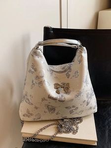 Beige butterfly chain tote bag with gold metal bow and floral prints for women