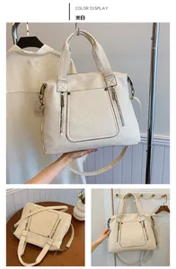 Detailed view of off-white large tote bag with vertical zippers and detachable strap