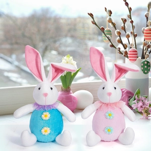 Detail of pink and blue Easter bunny gnomes with daisy decor on a festive windowsill