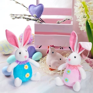 Easter gnome bunny figurines set with colorful floral decor and wooden fence display