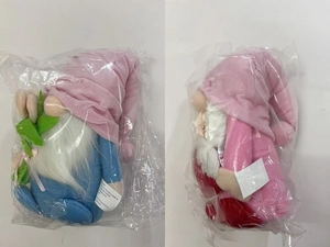 Detail of plush faceless gnomes with love heart and tulip in clear plastic packaging