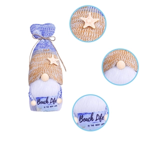 Detail view of summer gnome doll featuring starfish knit hat and Beach Life slogan