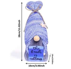 Close-up of a blue striped knitted gnome with starfish detail and beach text