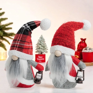 Christmas gnomes set with buffalo plaid and red knit hats holding vintage lanterns