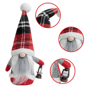 Detail of Christmas gnome with buffalo plaid hat and vintage oil lamp ornament