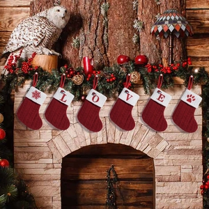 Set of 6 red knitted Christmas stockings with LOVE letters and snowflake patterns hanging