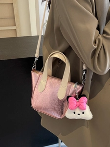 Pink glossy pleated crossbody bucket bag with cute plush doll charm and strap