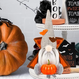 Halloween vampire gnome with white beard and pumpkin on a festive autumn background
