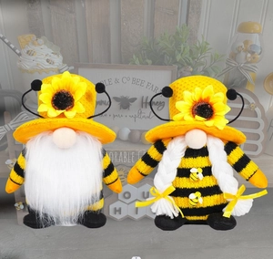 Close-up of plush bee gnomes with sunflower hats and black and yellow striped outfits